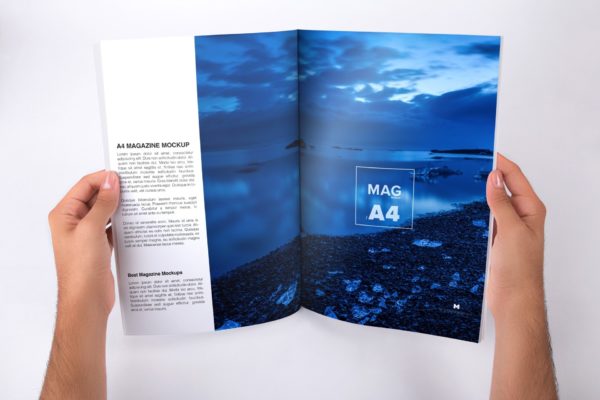 手持A4大小杂志内页版式设计打开效果图样机 Holding A4 Magazine Opened Mockup